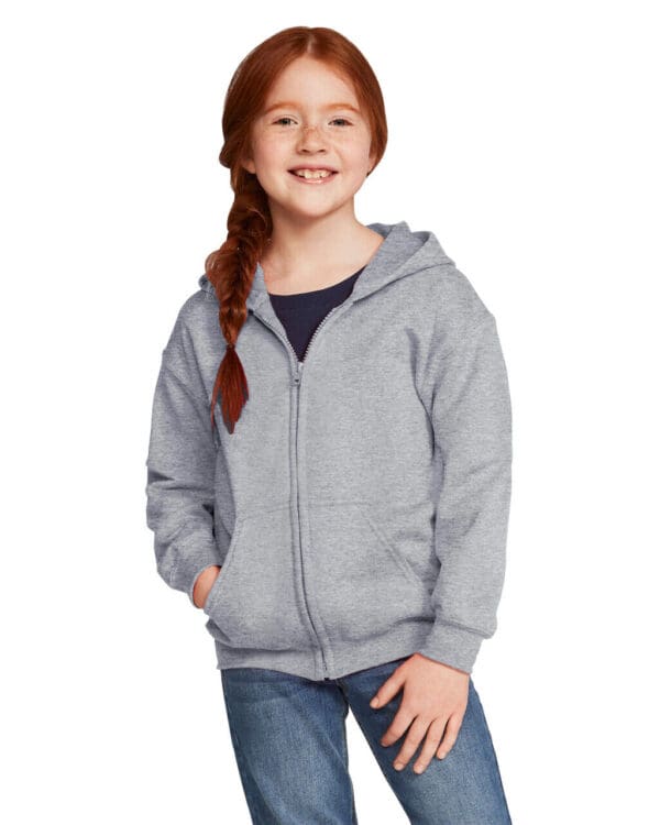 Smiling girl with red hair in hoodie.