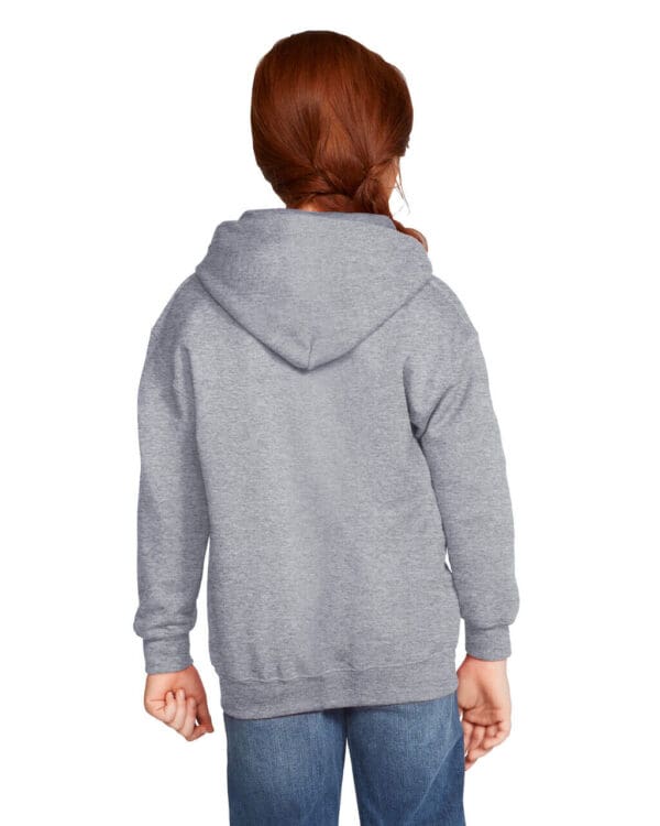 Child in gray hoodie, facing away.